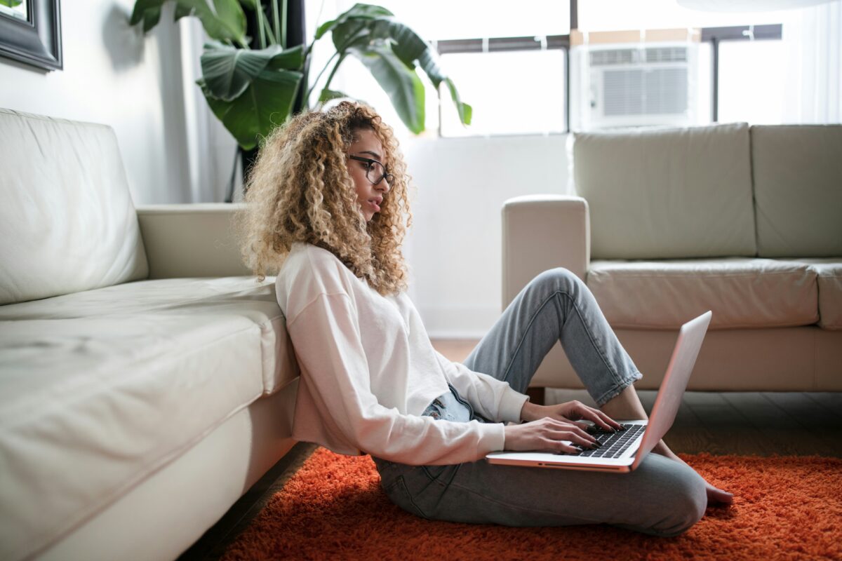 Doomscrolling pictured: woman typing on laptop