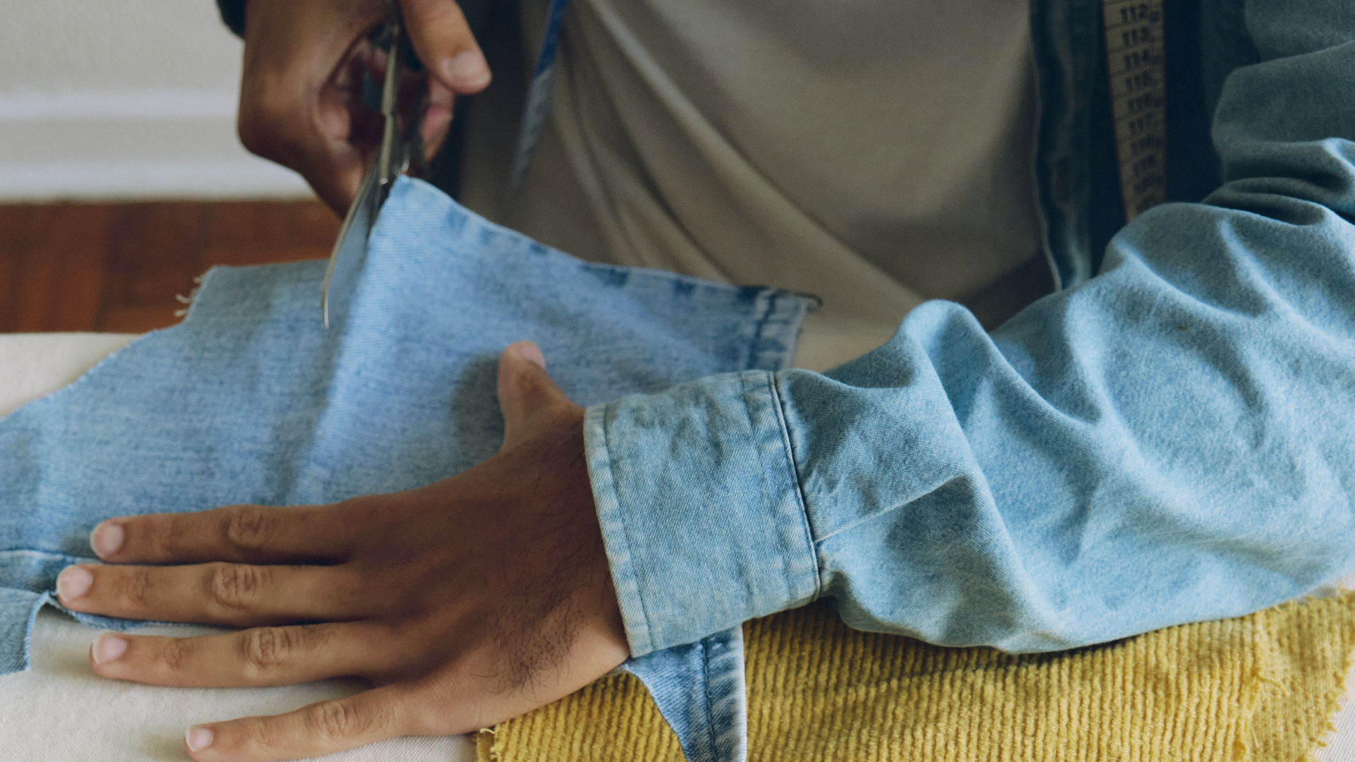 Man cutting jean material