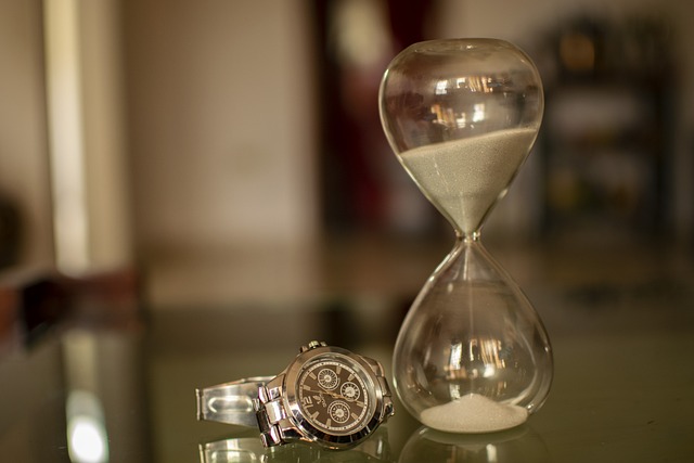 Hourglass and watch featured a tan and gold background