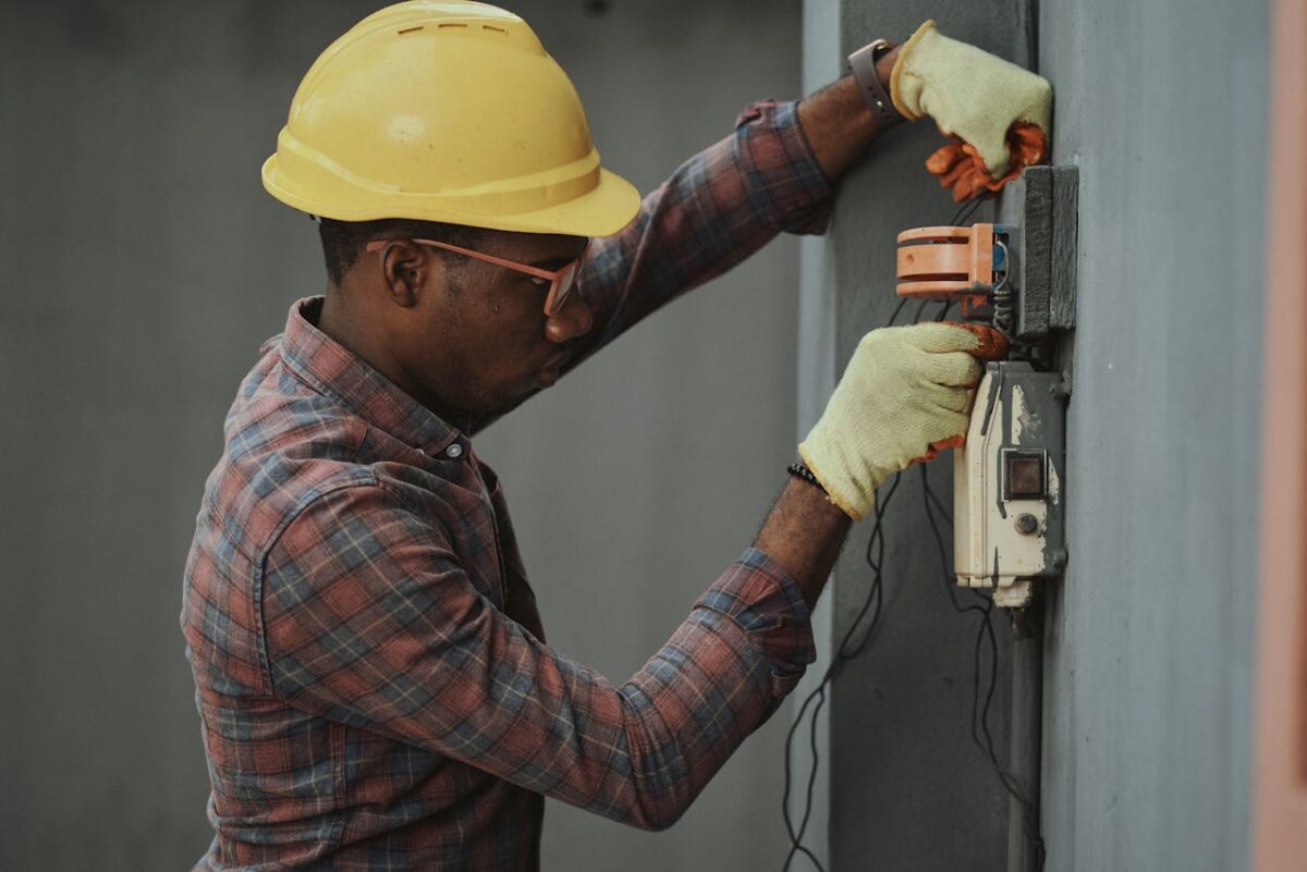 Electrician repairs a fuse box