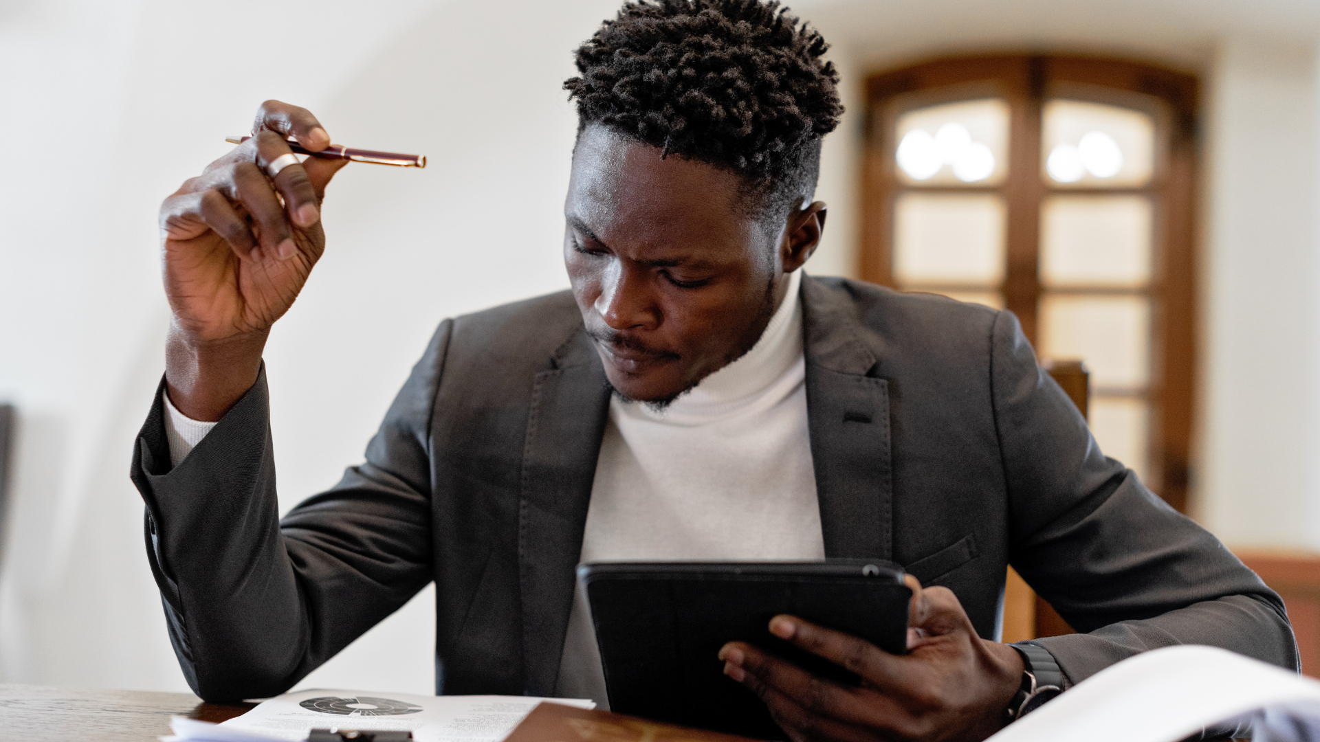 Man in Black Suit Holding Black Tablet Computer 